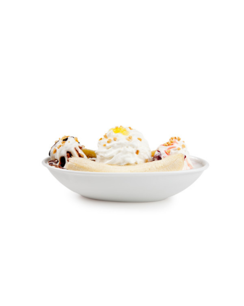 Banana split dessert in a white bowl with vanilla ice cream scoops banana halves whipped cream chocolate syrup and chopped nuts