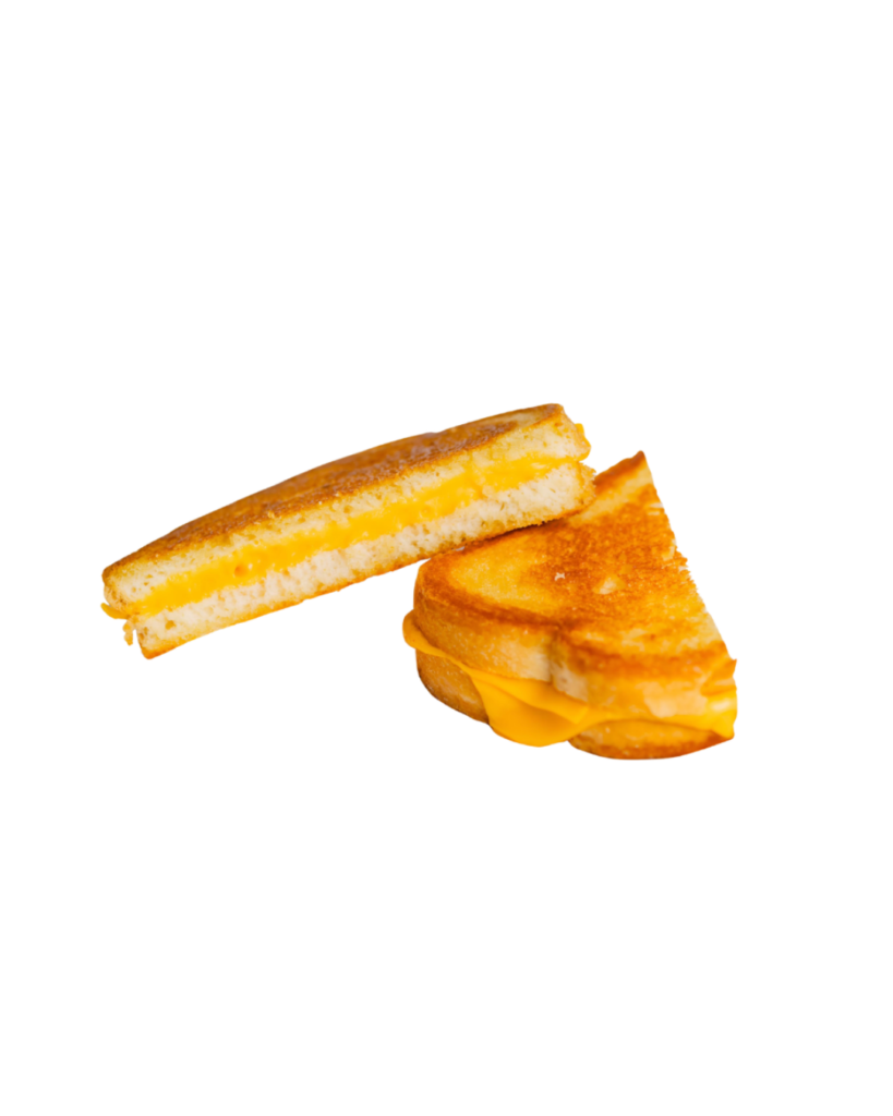 Grilled cheese sandwich cut in half with melted cheddar between toasted slices on a white platesymmetry placeholder
