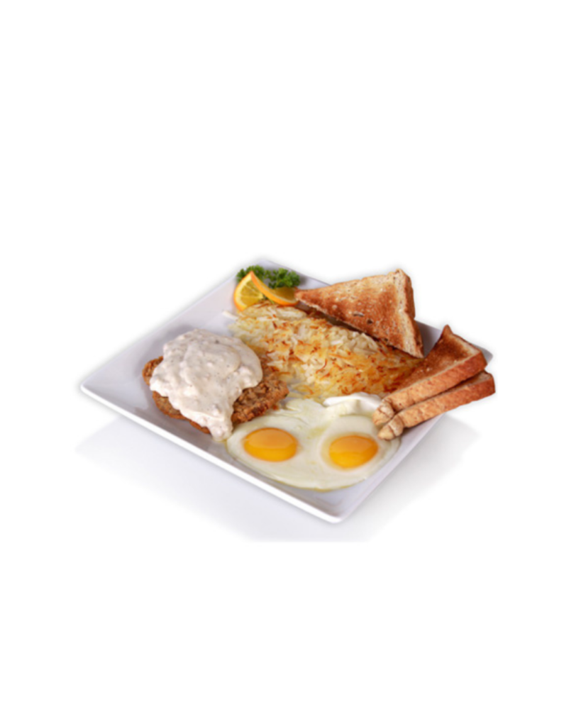Plate of breakfast two sunny side up eggs with rice toast triangles fried chicken with white gravy and an orange slice with parsley garnish