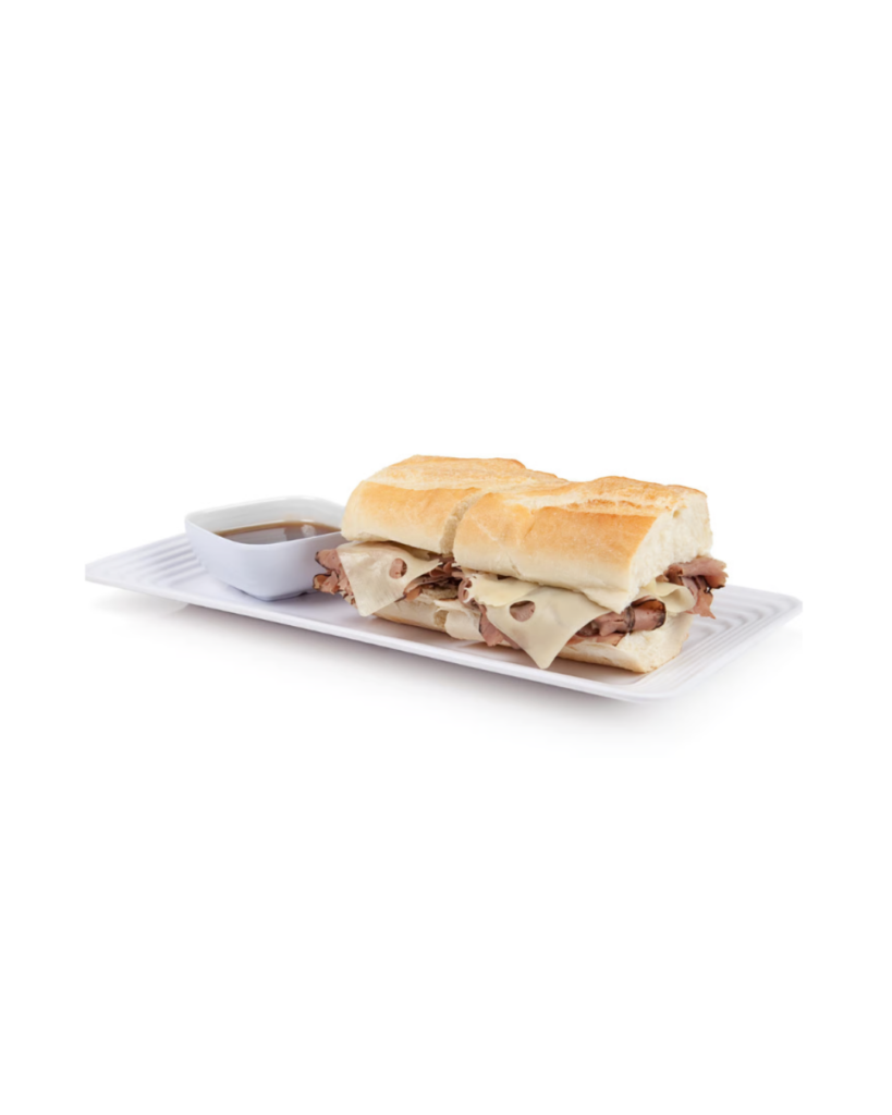 Sub sandwich with ham and melted cheese on a baguette served on a white plate with dipping sauce