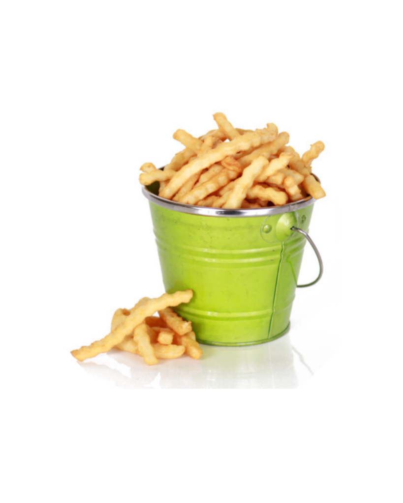 Green metal bucket filled with french fries on a white background with a few fries spilled nearby