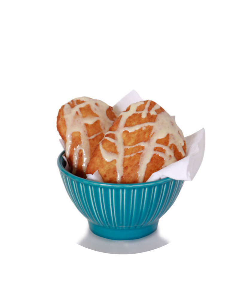 Two glazed muffins in a teal ribbed bowl lined with napkins on a white background circle