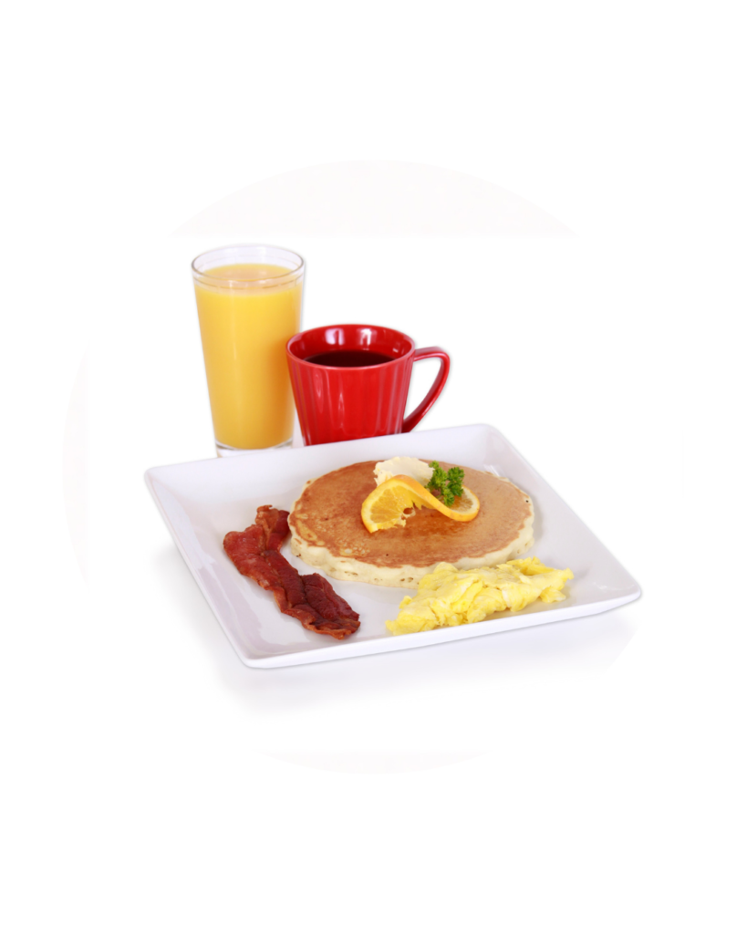 Plate with pancakes scrambled eggs bacon orange slice garnish a glass of orange juice and a red mug of coffee on a white square plate