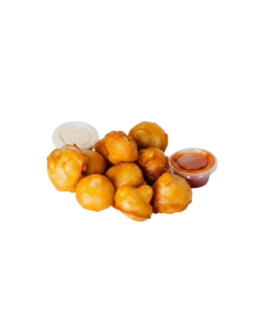 Pile of golden fried hush puppies with white and red dipping sauces on a white background