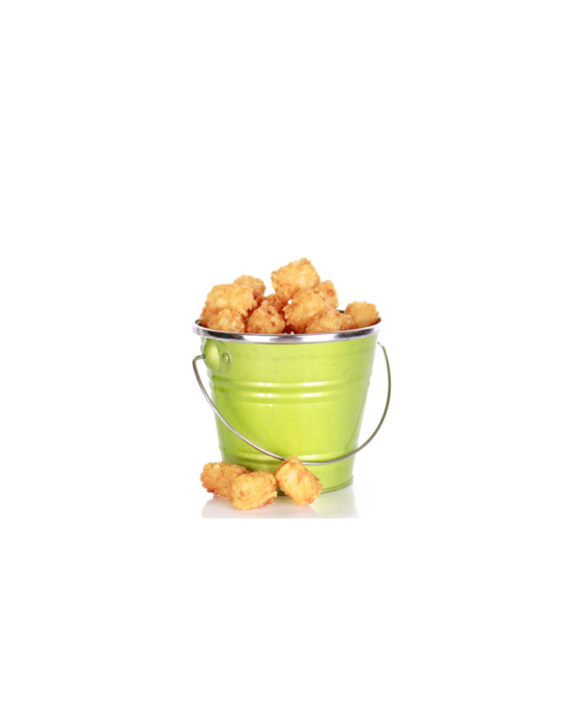 Green metal bucket filled with popcorn on a white background with a few pieces on the base nearby