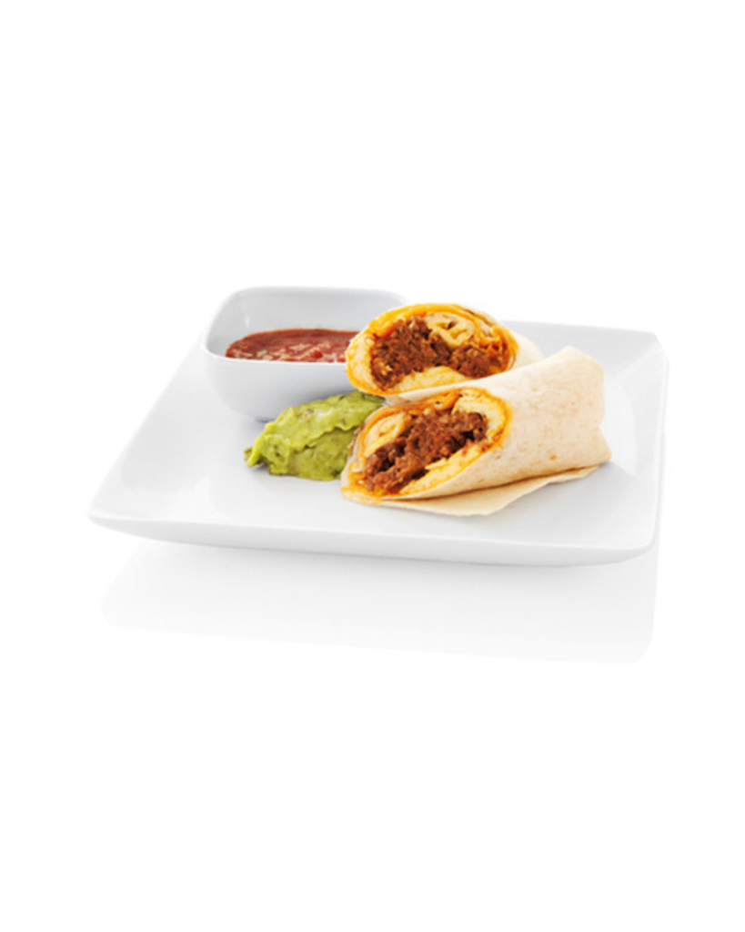 Two beef filled burritos cut open on a white plate with guacamole and salsa on the side