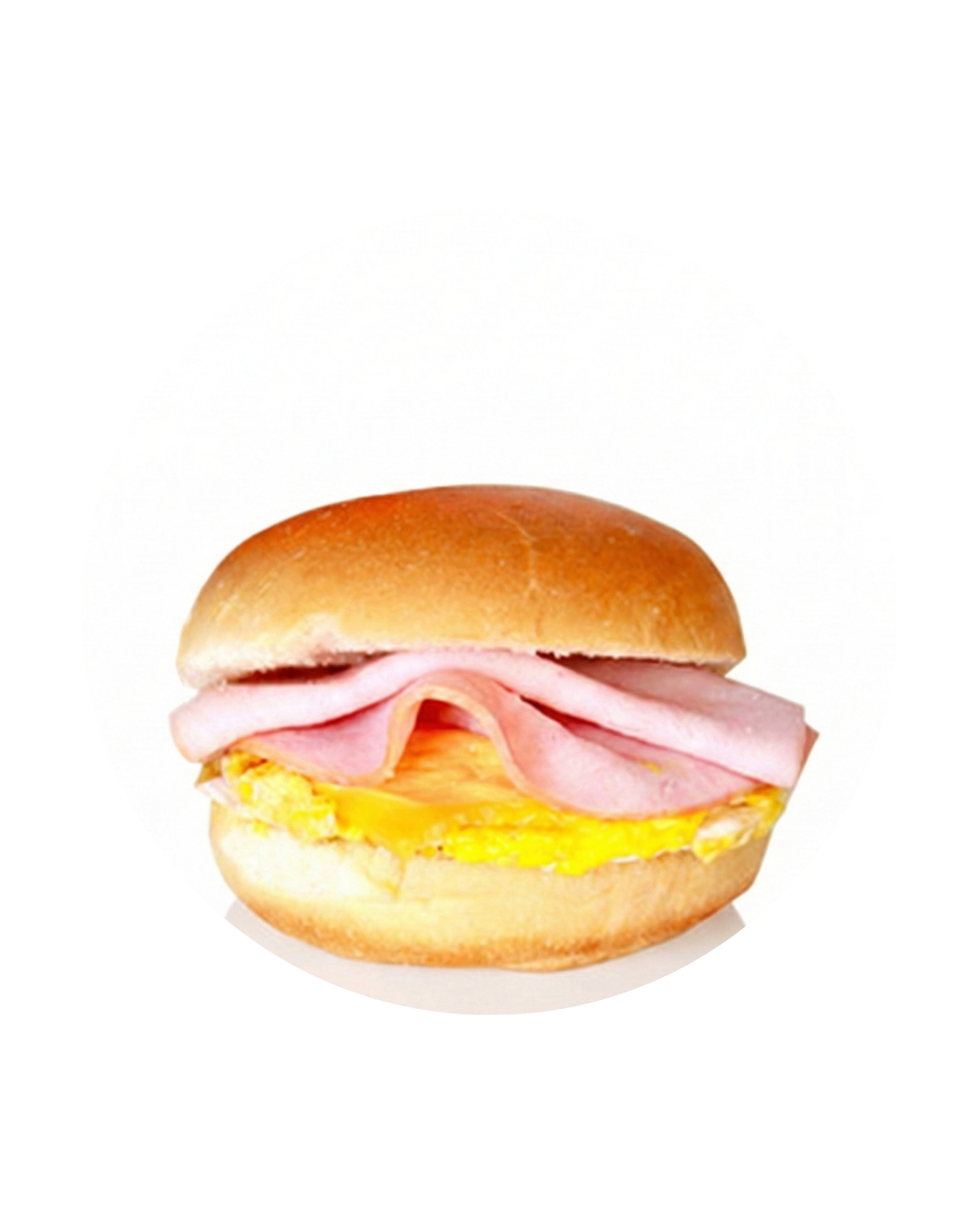 Breakfast sandwich with ham, egg, and melted cheese on a soft bun
