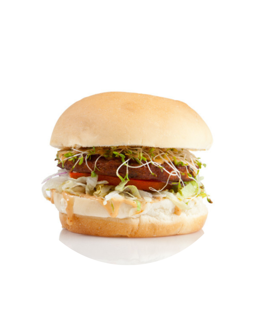 Hamburger with beef patty lettuce sprouts and sauce on a soft bun close up