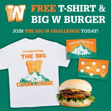 Promotional banner featuring a white t-shirt with an orange 'THE BIG W CHALLENGE' design, a mountain graphic, a free burger offer and a large 'FREE T-SHIRT & BIG W BURGER' headline.